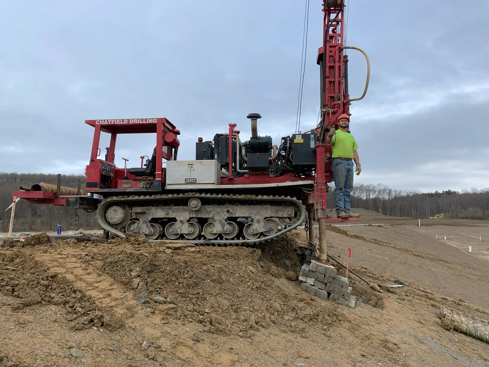 A Chatfield driller with the red rig on location